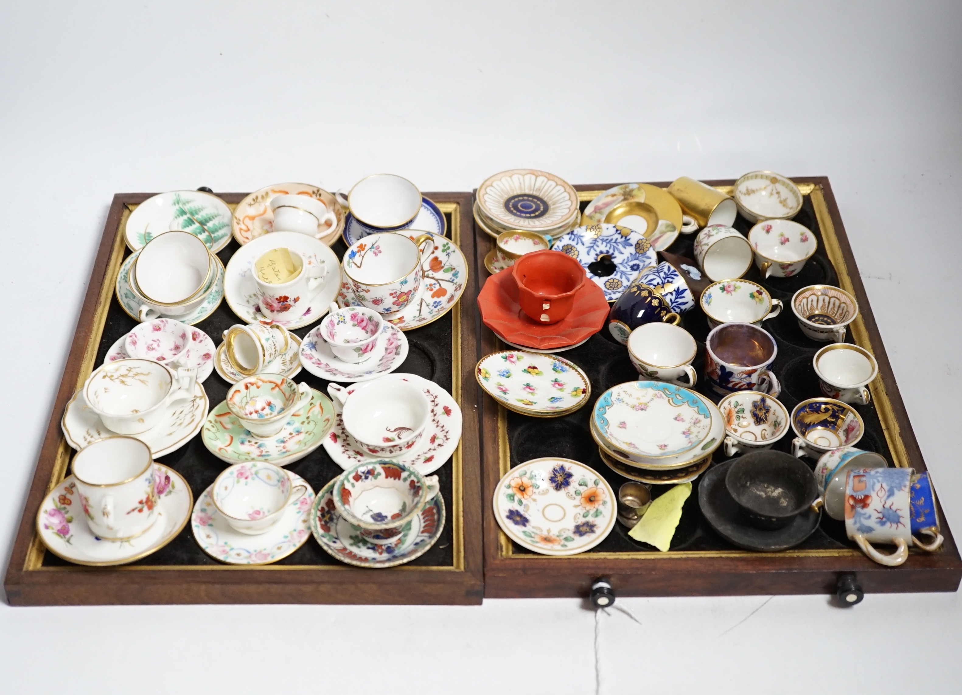 Collection of miniature porcelain cups and saucers including Spode, Royal Crown Derby and Coalport